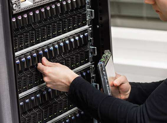 Engineer installing hardware in a server rack